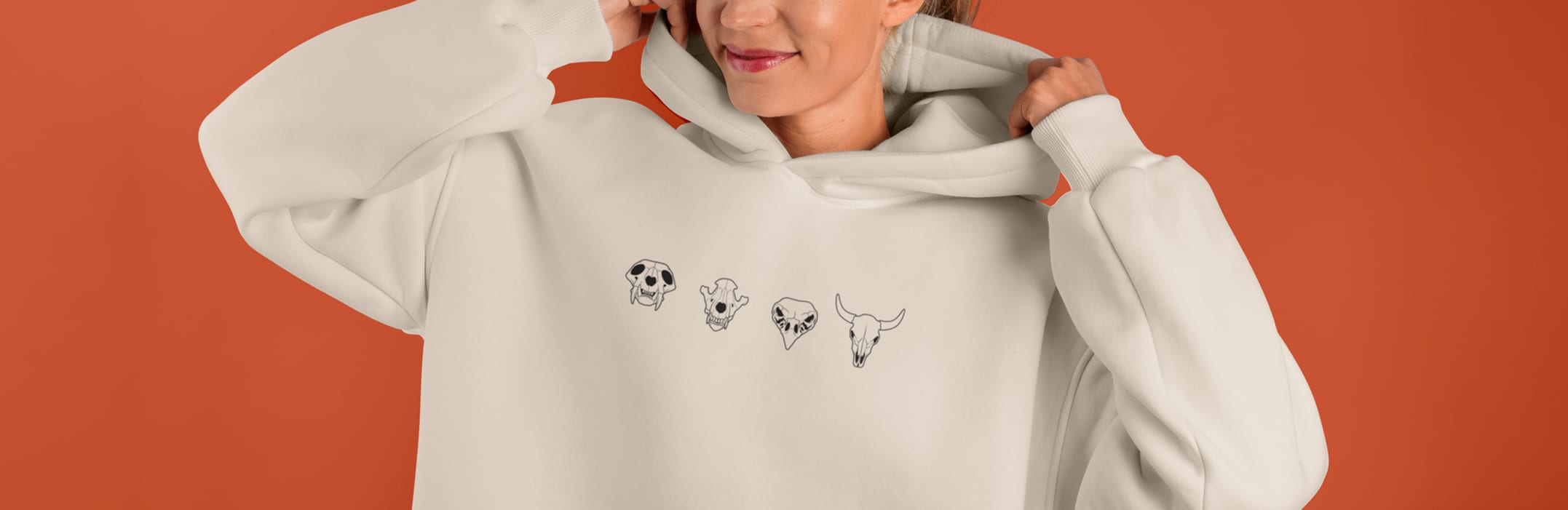 Model in a bone hoodie with the four skull symbols printed across the chest