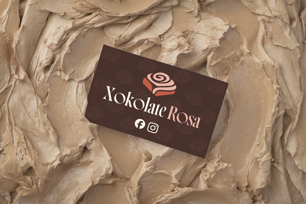 Xokolate Rosa brand in use — business card on textured chocolate-coloured background