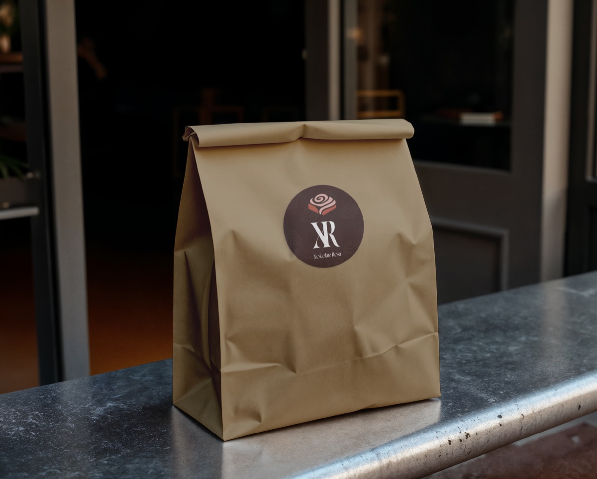 Xokolate Rosa brand identity — kraft paper bag with logo